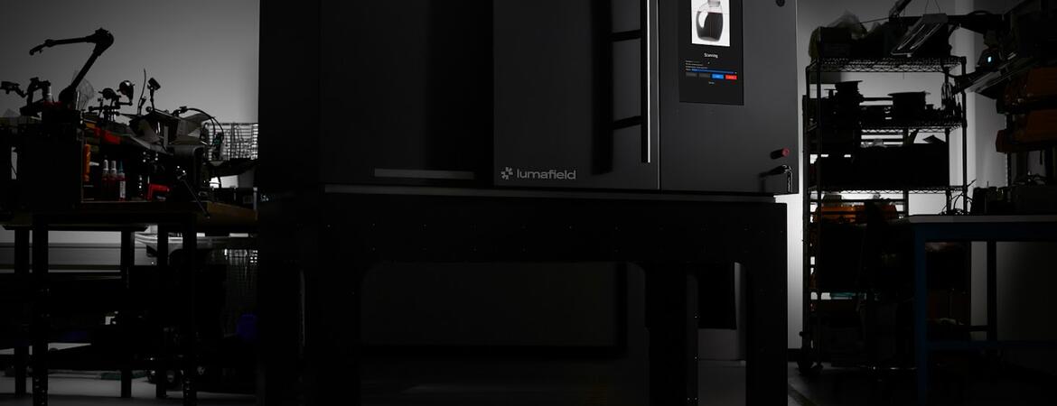 Lumafield Neptune industrial CT scanner shown in a dark studio setting.