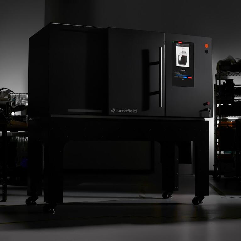 Lumafield Neptune industrial CT scanner shown in a dark studio setting.