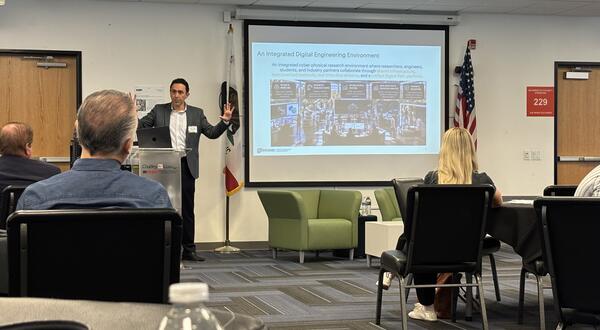 Kavan Hazeli presents the UCR Advanced & Integrated Manufacturing Hub to manufacturing and industry leaders at the MCIE annual meeting.
