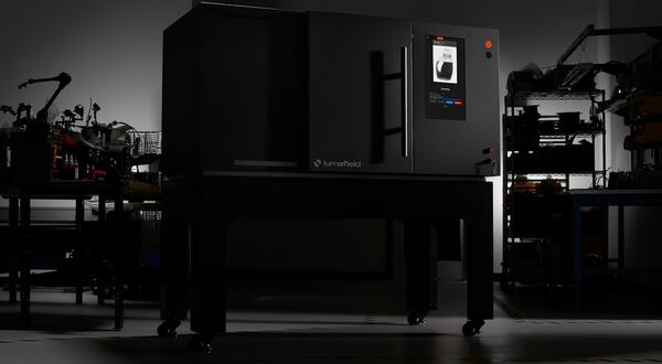 Lumafield Neptune industrial CT scanner shown in a dark studio setting.