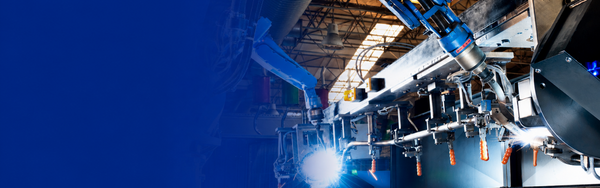 Robotic arms operate advanced manufacturing equipment on a factory floor with a blue gradient overlay.