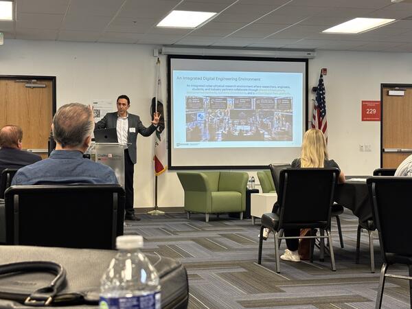 Kavan Hazeli presents the UCR Advanced & Integrated Manufacturing Hub to manufacturing and industry leaders at the MCIE annual meeting.